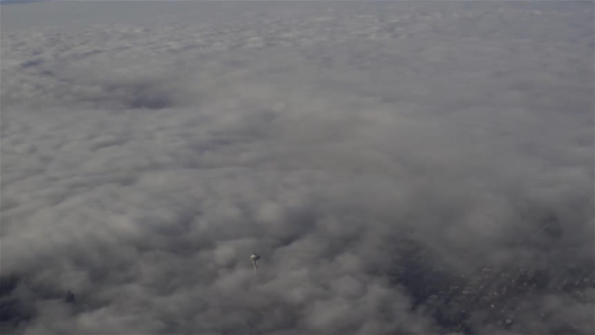 A city with buildings and roads and clouds