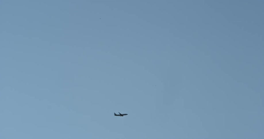 Airplane takes off into the wide blue sky