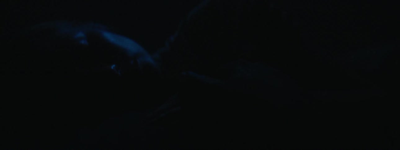 Man and woman sleeping in a dark room