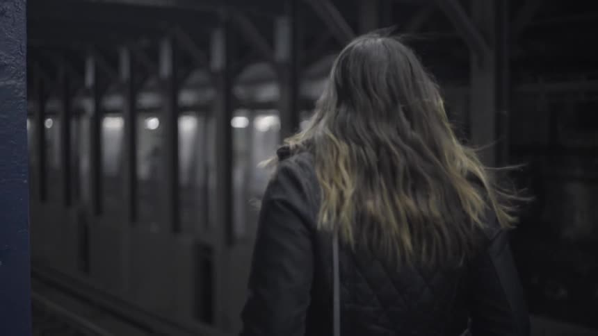 Woman walking along a train platform
