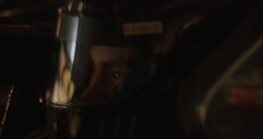 A man is driving a racing car in daylight