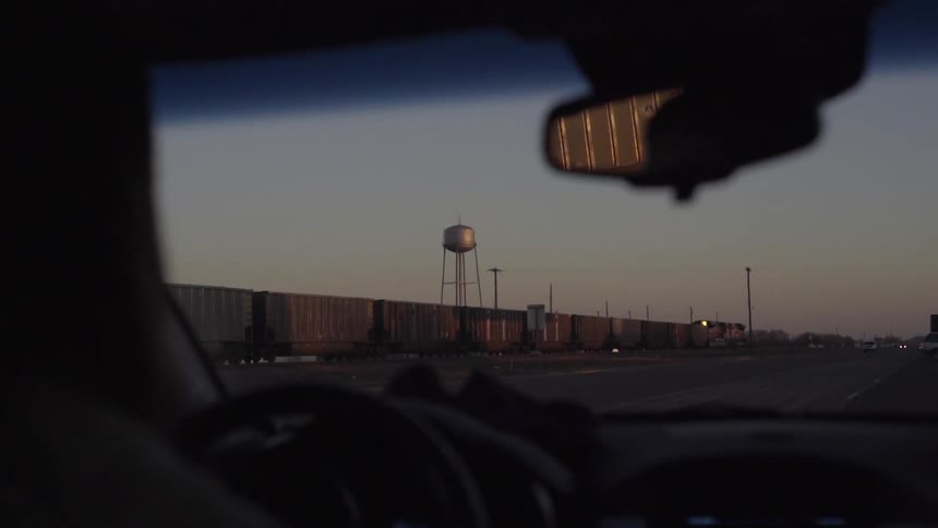 A car driving past a train