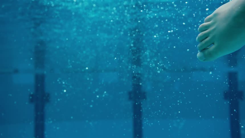 A person swims in a pool