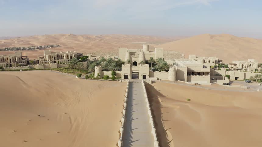 Buildings stand in the middle of a desert