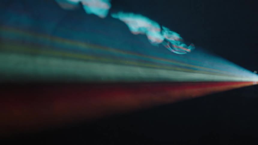 Smoke billows into a beam of light