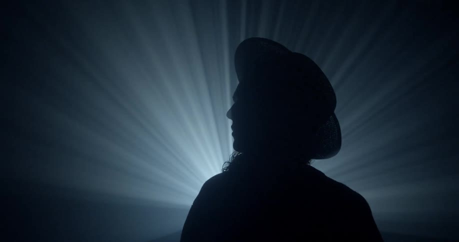 Bright lights silhouette a person