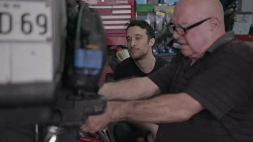 A man is working on a machine in the shop