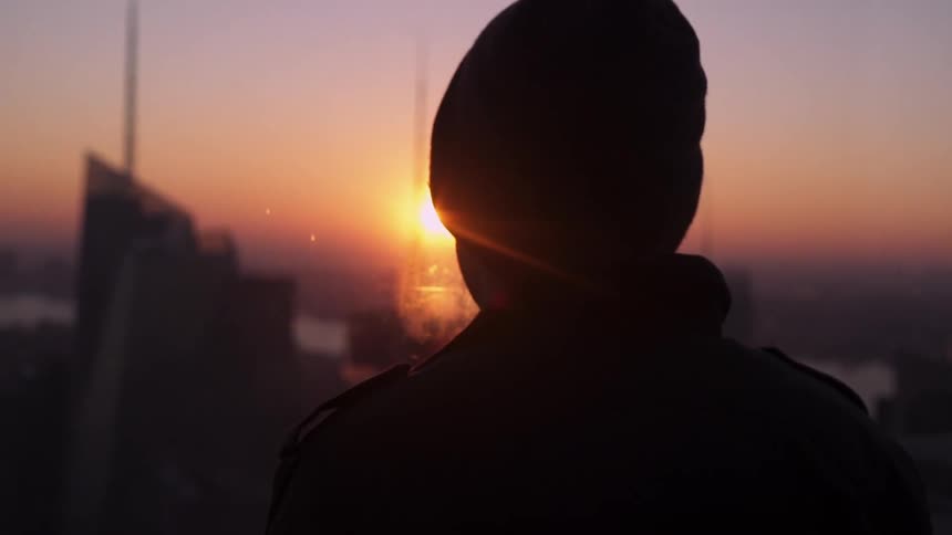 A man is watching the sunset