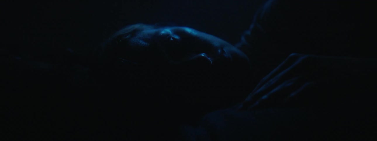 Lights flash around a woman trying to sleep