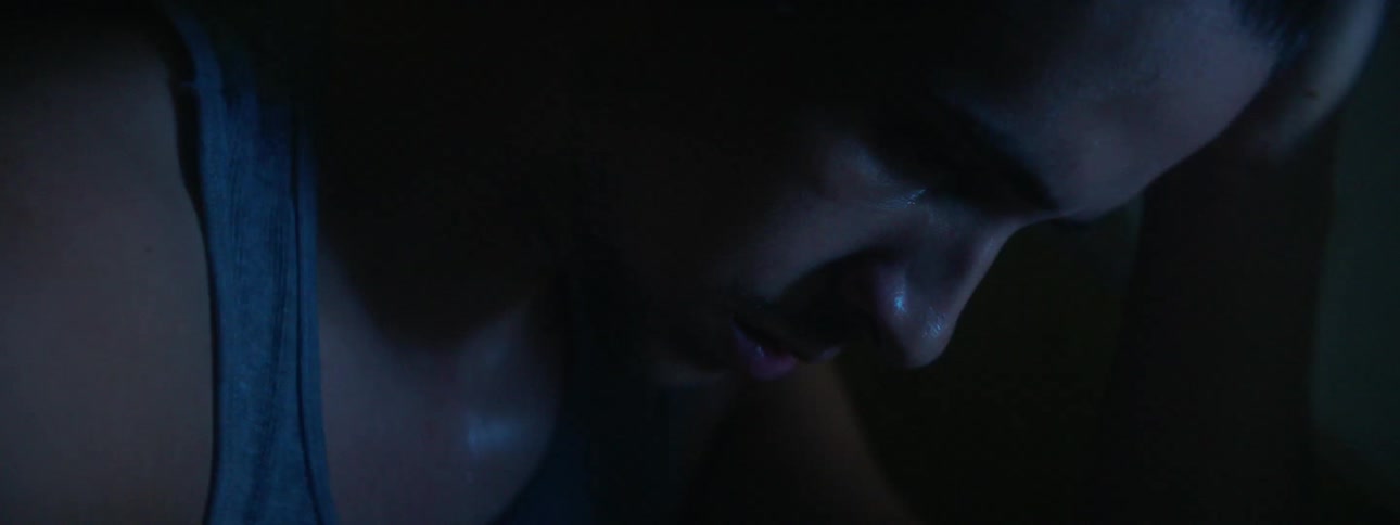 A man screams while lights flash around him