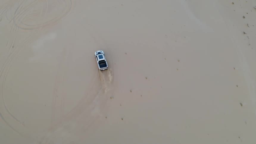 Truck turns donuts in a desert