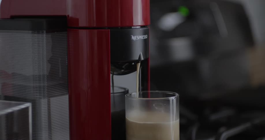 A coffee maker brews a cup of coffee