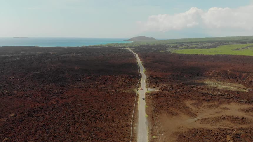 Vehicles approach each other on a long rural road