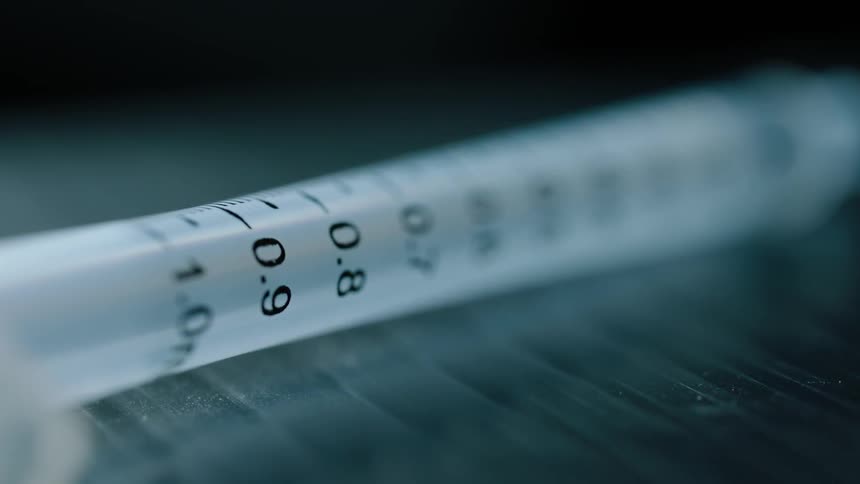 Syringe with line markings lays on a table