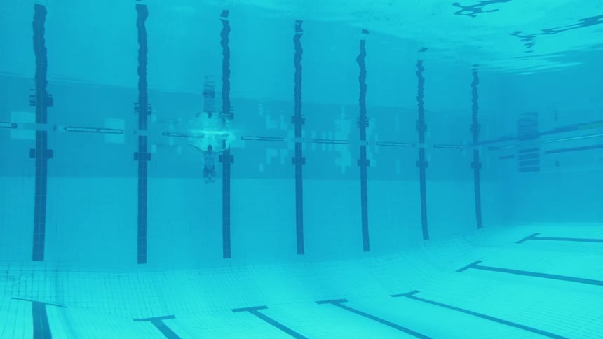 A man jumps into a swimming pool