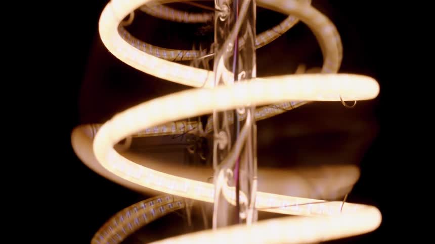 A twisting and turning piece of illuminated metal