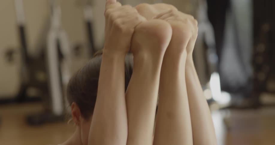 A woman is doing yoga in the gym
