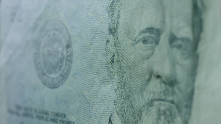 Man stares out from an american paper currency