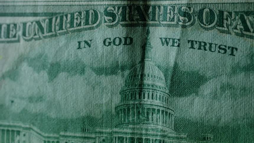 A currency bill is slowly lit up