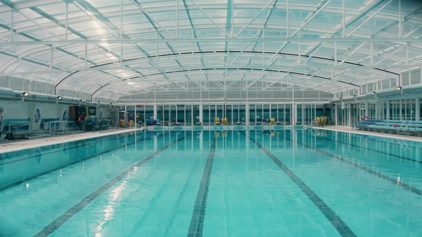 The lights are on at an indoor swimming pool