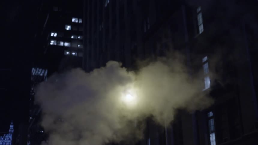 Steam billows from a city street