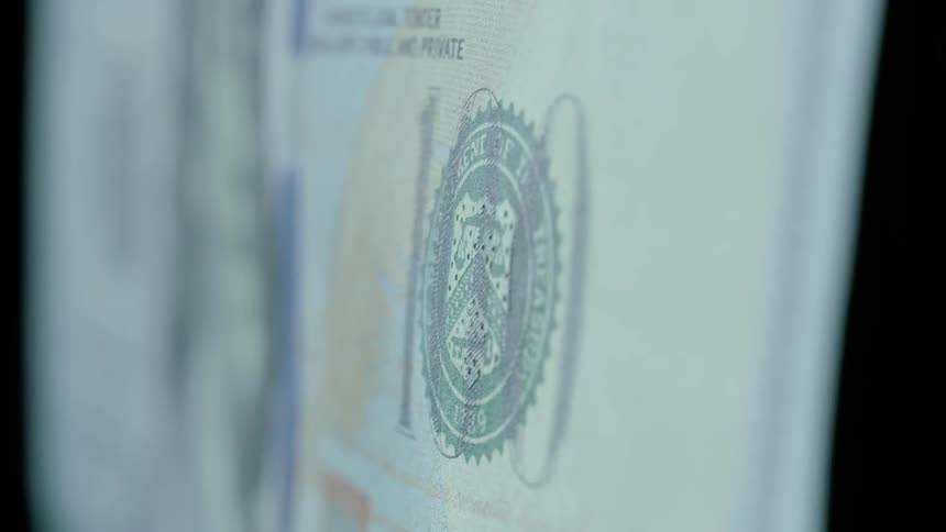 A dollar bill standing up in a dark room
