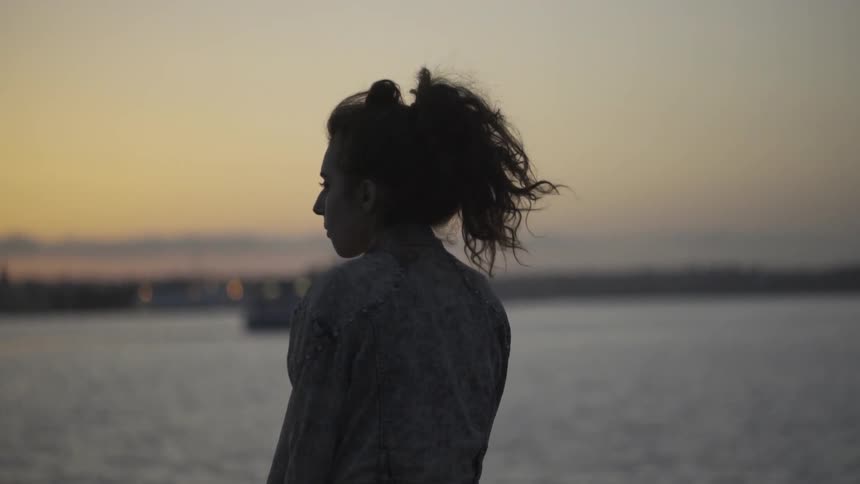 A woman is watching the boats