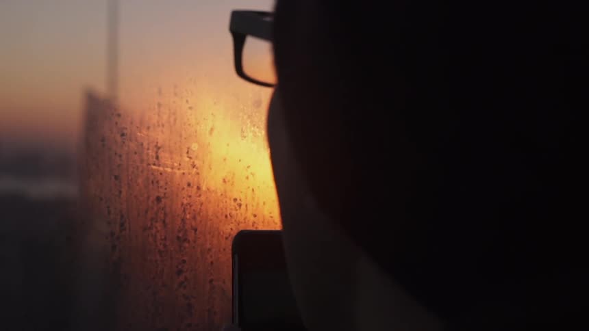 A man is fogging up a window