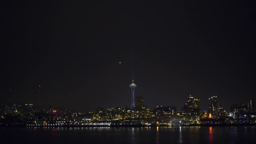 Lakeside city skyline at night