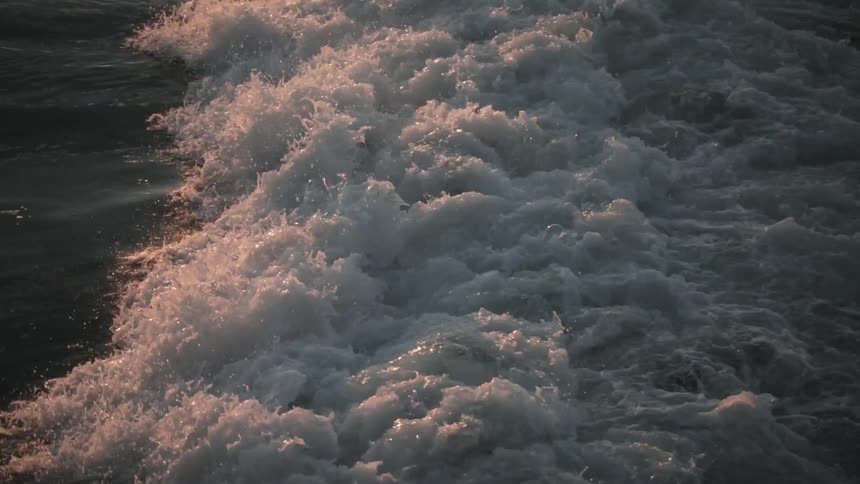 Water rushing forward as it reflects light
