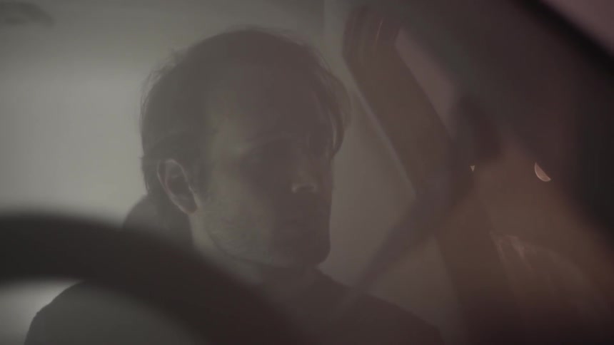A man is driving in the fog