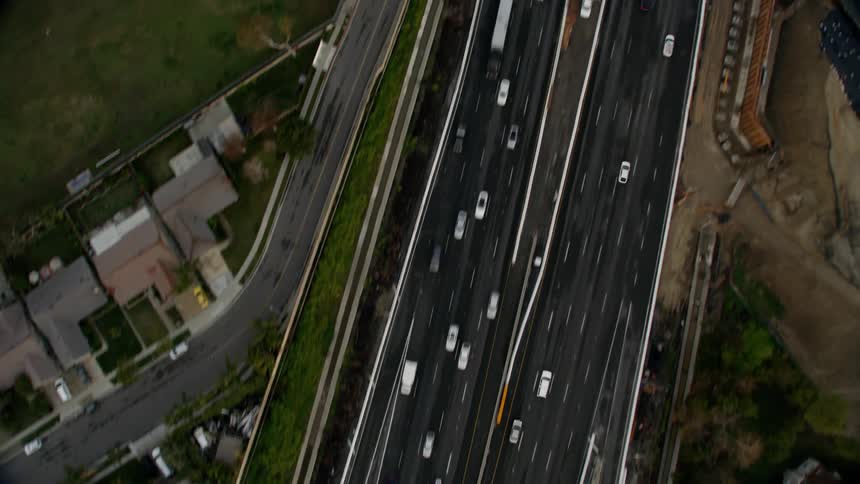 Cars drive on a city street