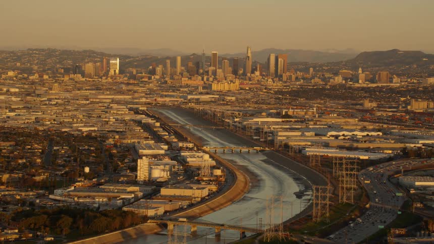 Cars drive over city bridges at sunset