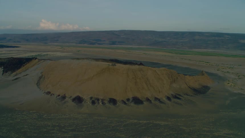 A large crater sits in the middle of the landscape