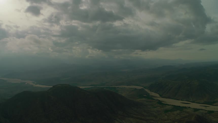 The large clouds roll over the hills ahead
