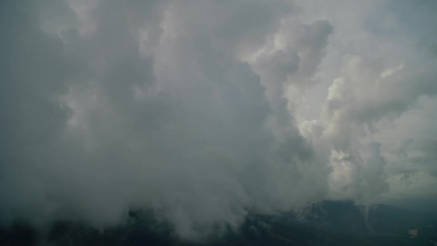 Clouds hover low and touch hill tops