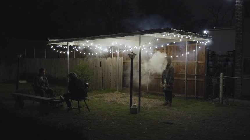 A family is outside at night