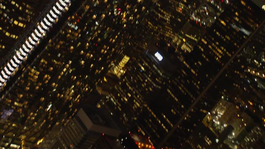 Skyscrapers illuminate a dark night sky