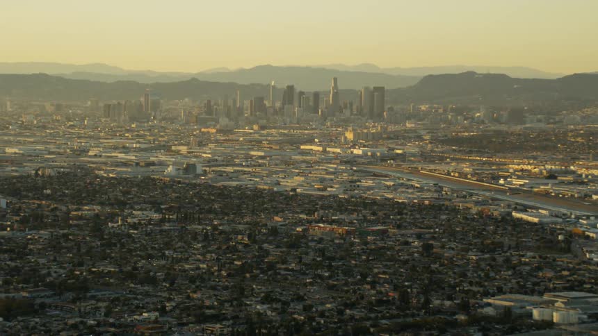 A cityscape is shown at sunset; Los Angeles