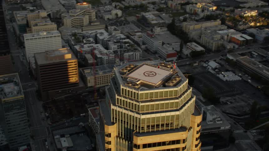 Flying above Downtown Los Angeles with Helicopter landing pads on top of skyscrapers