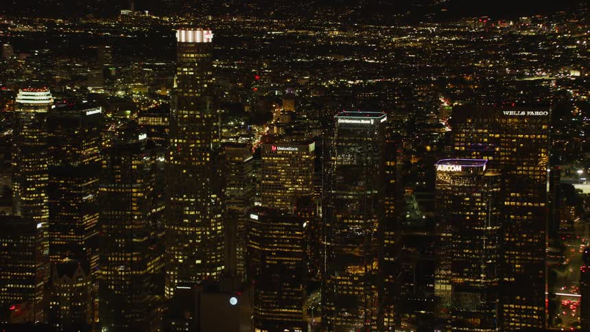 City skyscrapers light up the dark night sky in Downtown Los Angeles