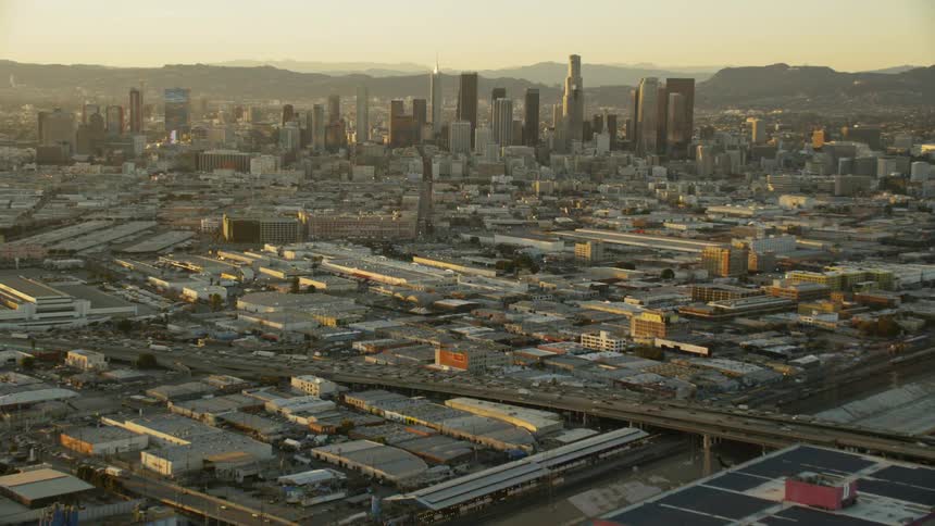 Vehicles travel on city roads at dusk; Los Angeles