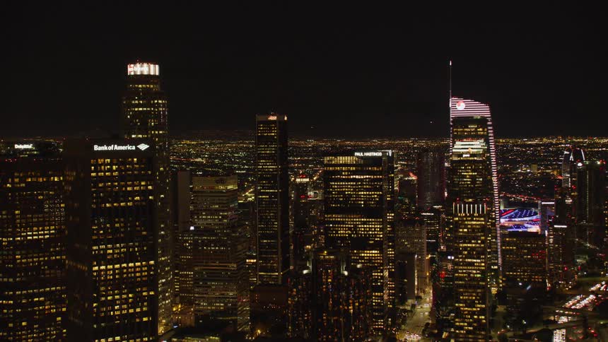 LA Skyline glows at night in the city; Downtown Los Angeles