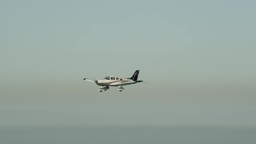 Small airplane flies in the sky