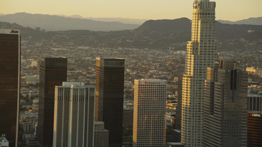 Sunlight shines on skyscrapers at sunset; Los Angeles