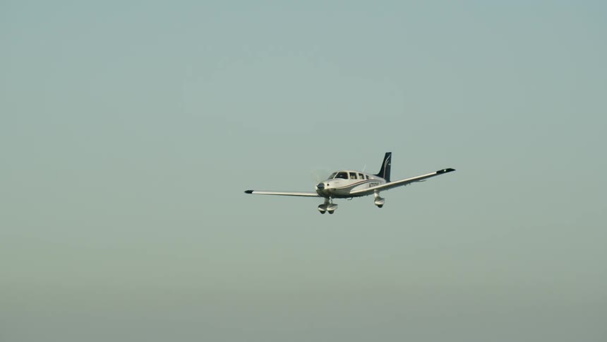 A small plane flies in the sky