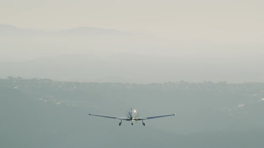 A small airplane flies in the sky