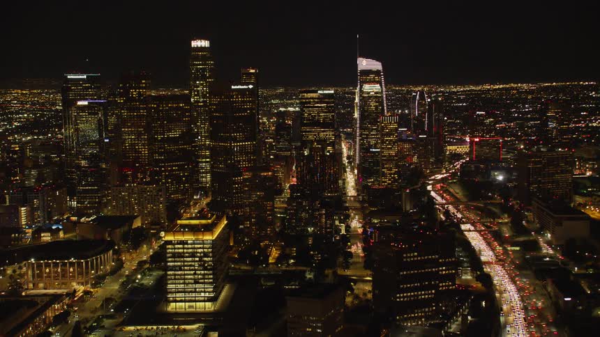 Traffic is flowing on a freeway system in Downtown Los Angeles at Night