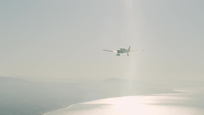 The plane is coming in for a landing in the foggy sky