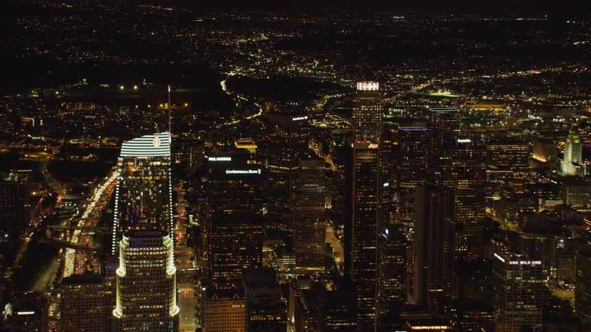 Large city with many skyscrapers lit up at night